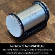 Close-up of the HONE Knife Sharpener roller resting in the black Vertical Strop stand with discs at both ends