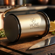 Close-up of the opposite end of the HONE rolling sharpener beside a knife