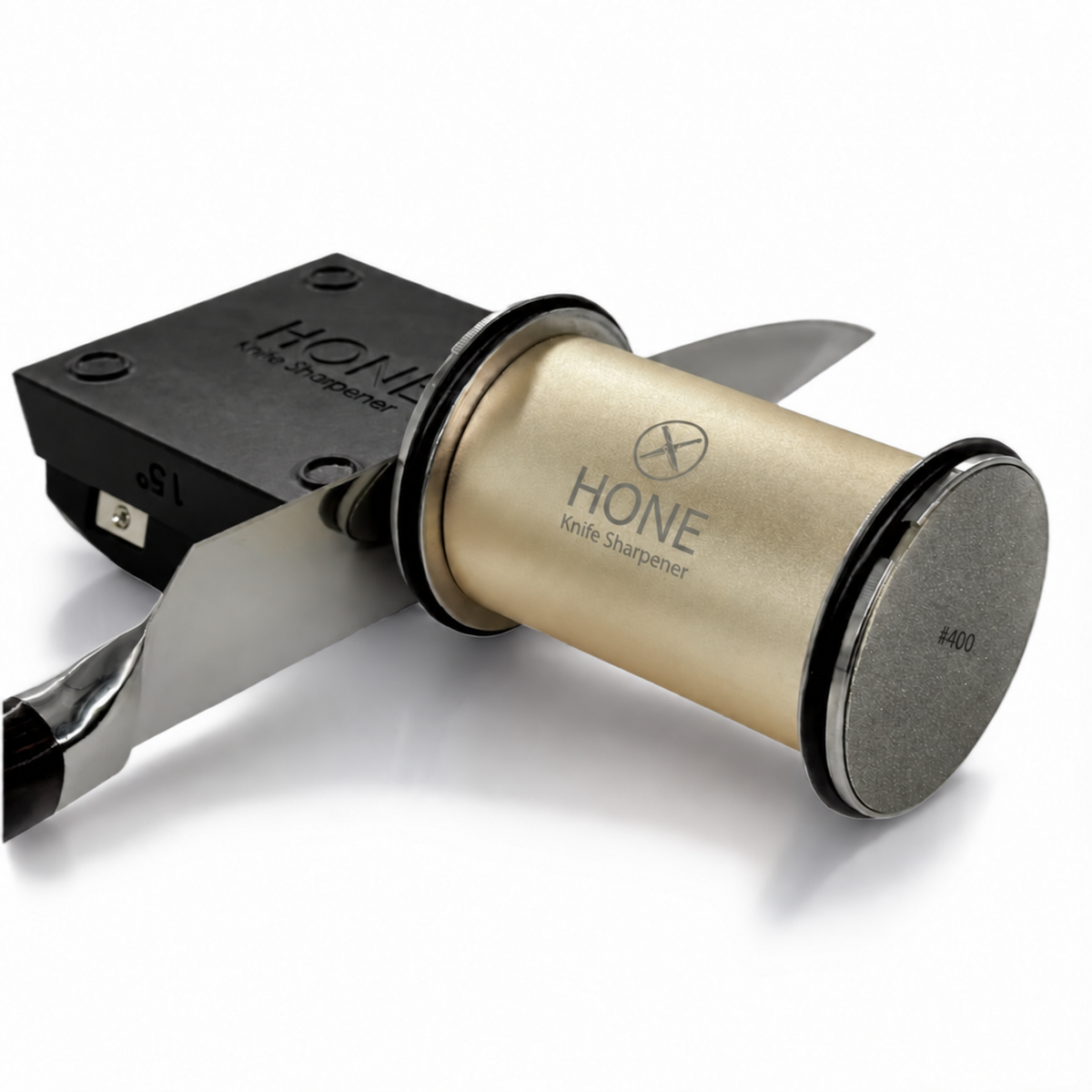 Real HONE gold rolling knife sharpener beside a kitchen knife supported by the magnetic knife holder